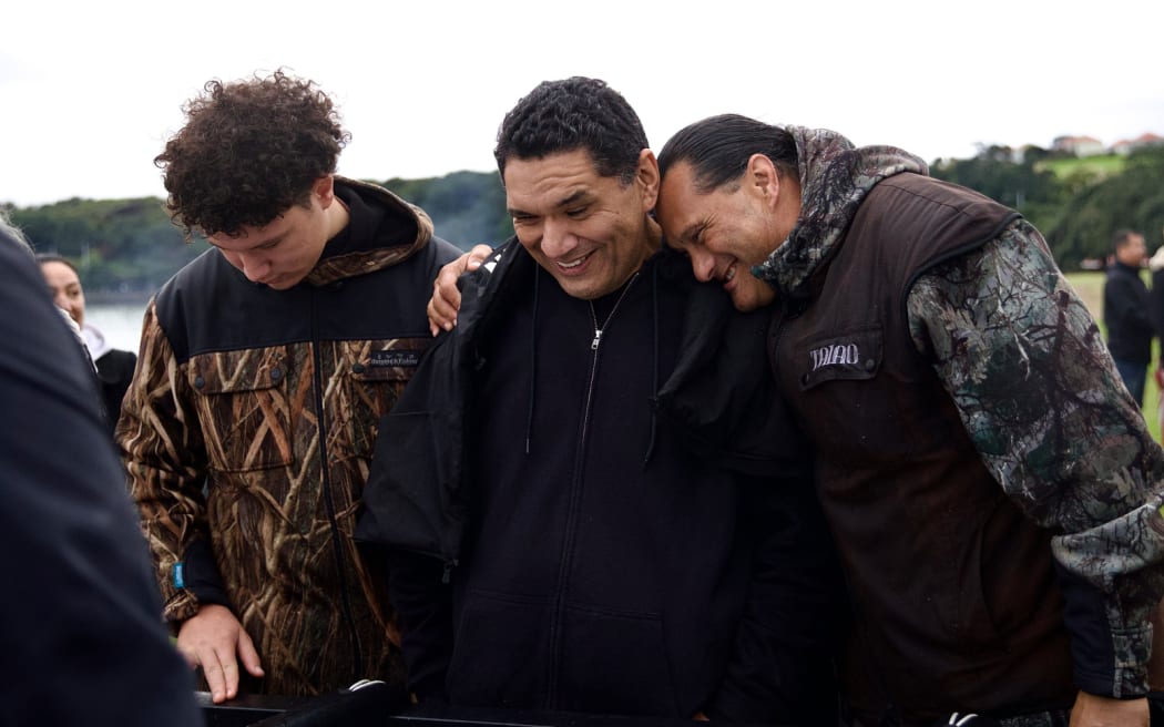 Master waka carver Hemi Eruera (centre) admiring Te Kowau