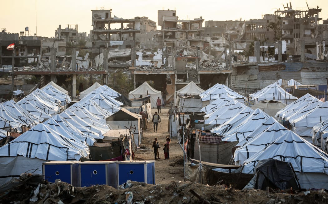 Young Palestinian girls play in a new displacement camp set up by the Egyptian Committee in Nuseirat, Gaza Strip on 11 November, 2025.