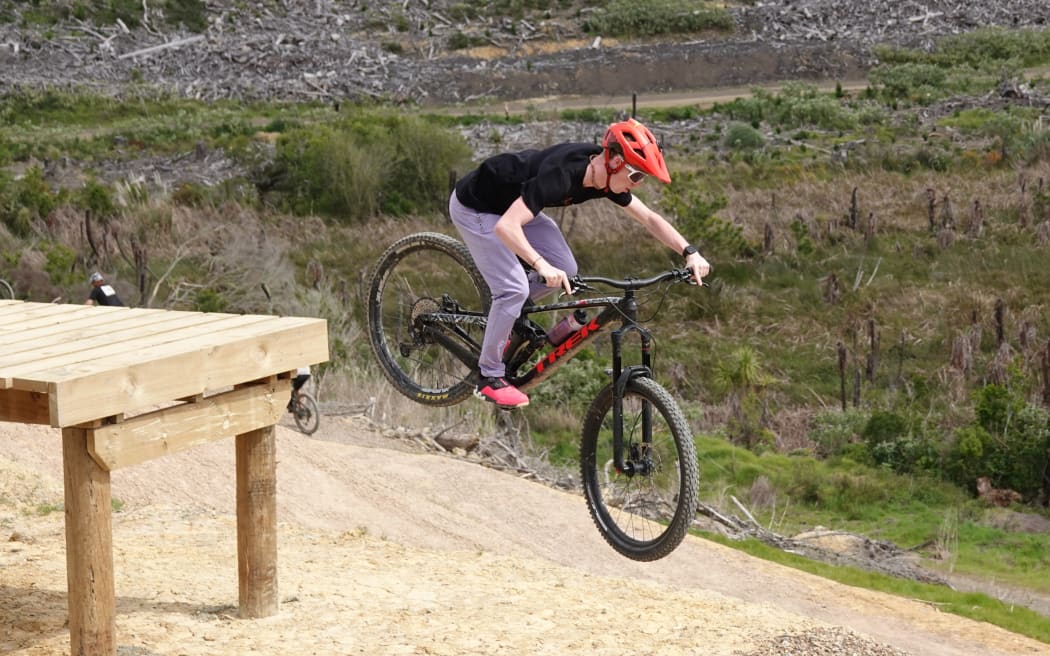 A rider commits to a drop on Puanga Matariki, the advanced jump line.