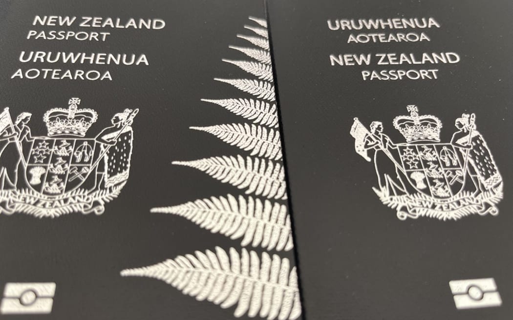 A 2016 and a 2023 New Zealand passport. The older passport features the English words first - a design the government says it will change back to with new passports from 2027.