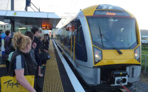 Commuters at Onehunga station as new electric trains start their regular runs.