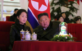 This picture taken on December 31, 2025 and released by North Korea's official Korean Central News Agency (KCNA) via KNS on January 1, 2026 shows North Korean leader Kim Jong Un, his daughter Kim Ju Ae (C) and wife Ri Sol Ju (L) watching a New Year's celebration performance at the May Day Stadium in Pyongyang.
North Korean leader Kim Jong Un has entrenched his daughter as heir apparent ahead of a landmark party conference, a South Korean lawmaker said on February 12, 2026 after a briefing from Seoul's main intelligence agency.
