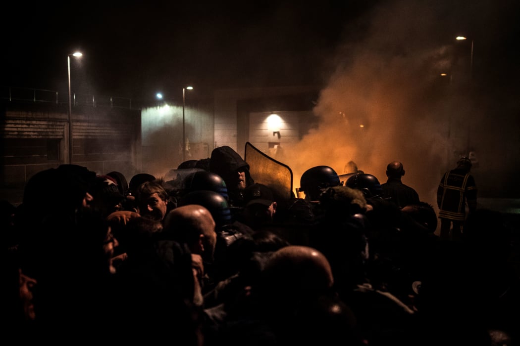 Striking prison guards clash with riot police in front of Villefranche-sur-Saone prison on Monday 22 January 2018.