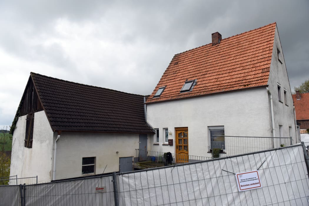 Dark clouds above the house of the accused married couple.