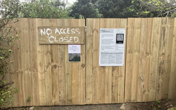 A bare timber fence with a sign reading "NO ACCESS - CLOSED" blocks a dirt path.