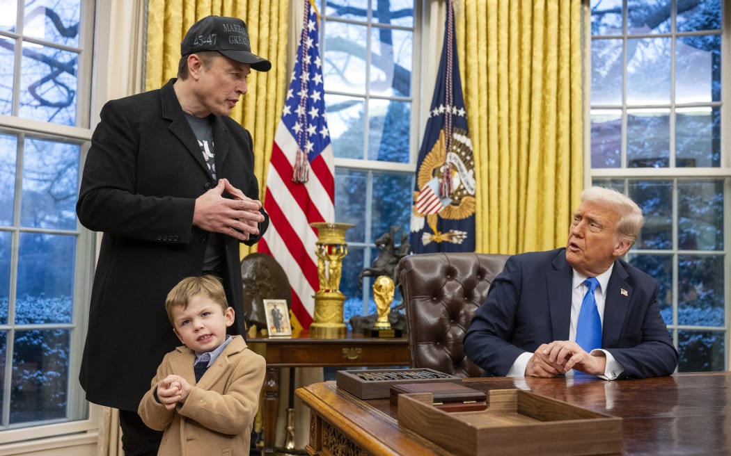 Tesla and SpaceX CEO Elon Musk with his son X Æ A-Xii join US President Donald Trump as he signs executive orders in the Oval Office of the White House in Washington, DC, February 11, 2025.