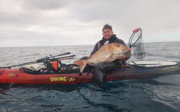 Chris Simons with the snapper he caught off the South Taranaki coast.