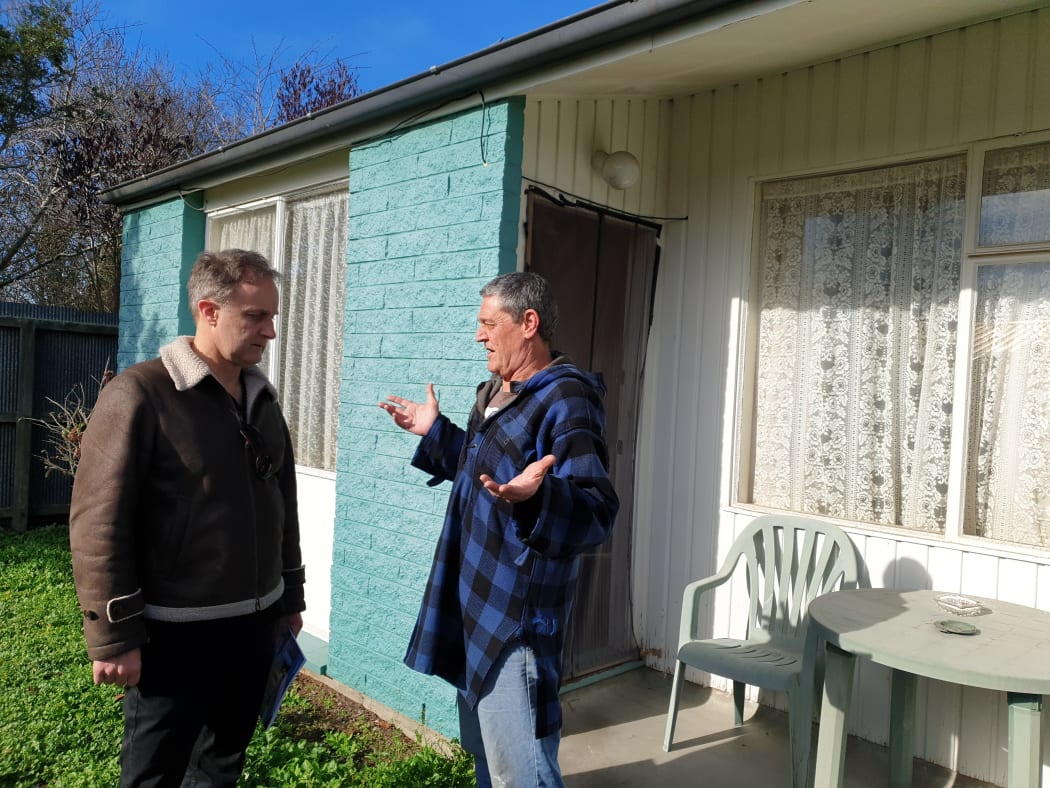 Building expert Bob Burnett talks to Frank Poissonnier at the social housing complex in Christchurch.