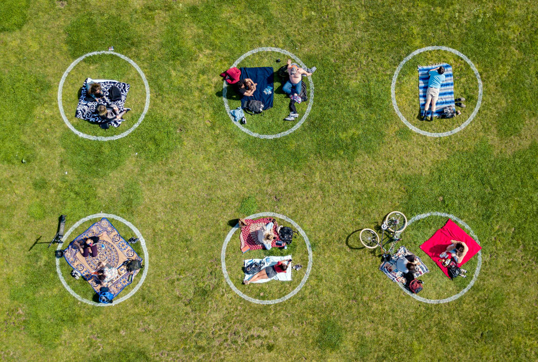 An aerial view shows people gathered inside painted circles on the grass encouraging social distancing at Dolores Park in San Francisco, California on May 22, 2020.