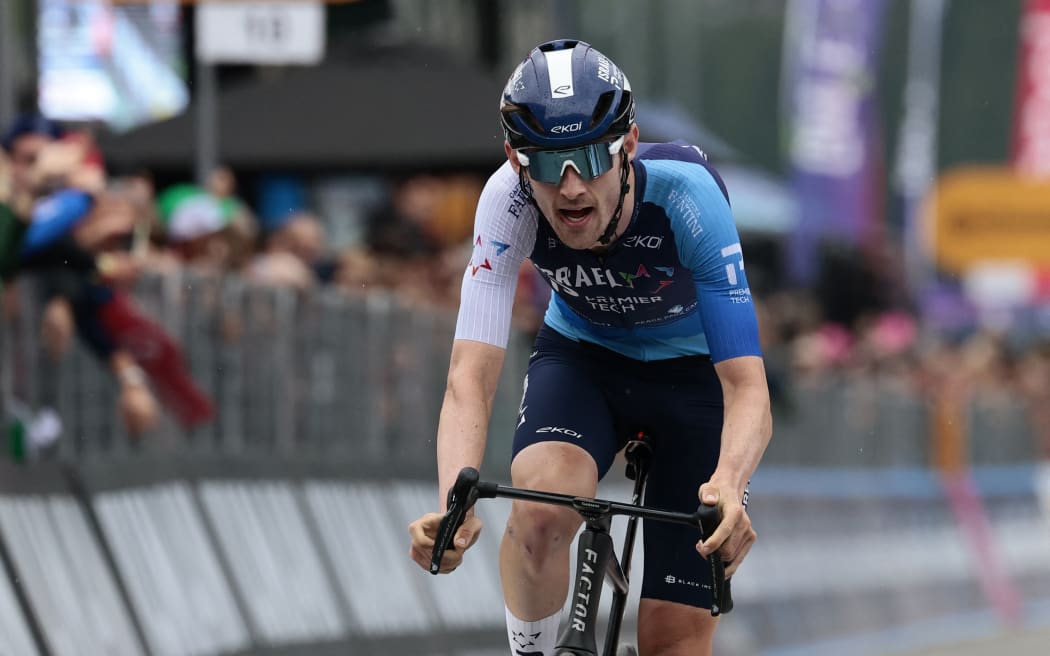 Derek Gee, riding for Israel-Premier Tech, crosses the finish line of the 17th stage of the 108th Giro d'Italia cycling race in Italy, May 28, 2025. (Photo by Luca Bettini / AFP)