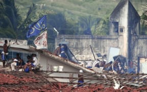 Police fired tear gas grenades at the inmates gathering on the roofs of the Alcacuz Penitentiary during recent riots.