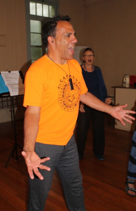A photo of choirmaster Rawiri Hindle singing.