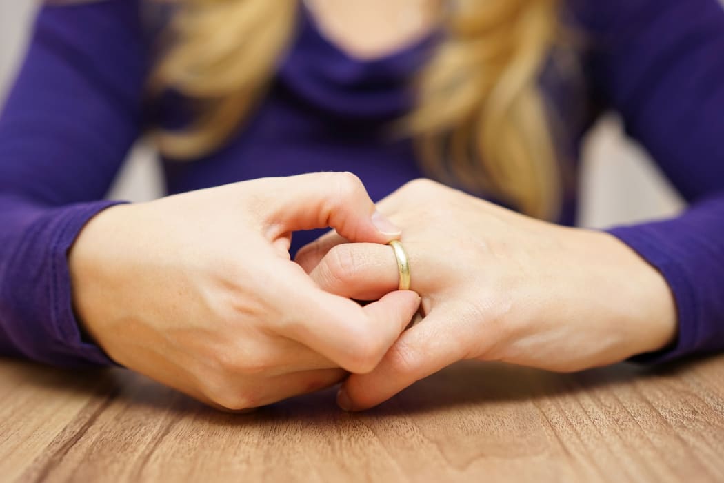 woman is taking off the wedding ring