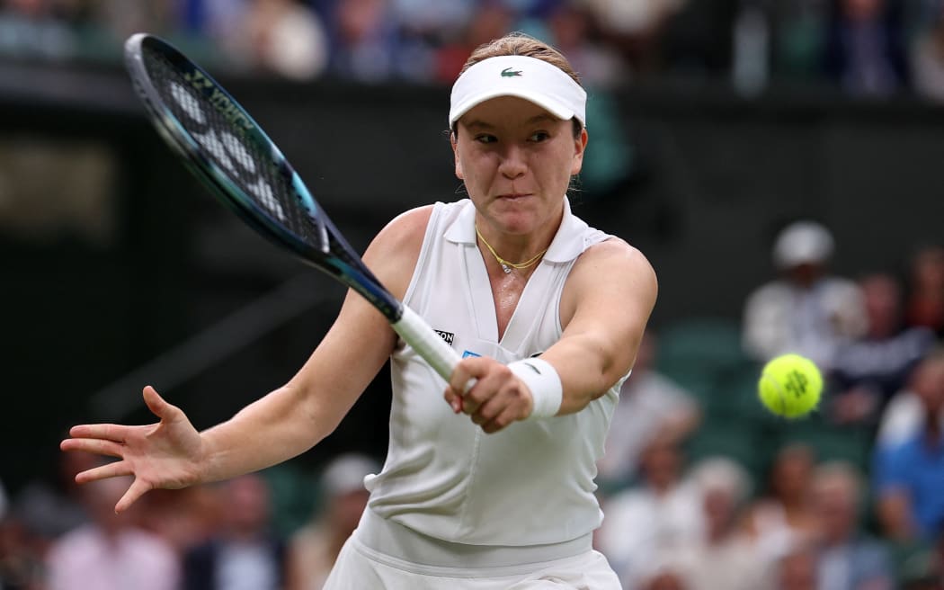 New Zealand's Lulu Sun returns against Britain's Emma Raducanu during their women's singles fourth round tennis match on the seventh day of the 2024 Wimbledon Championships at The All England Lawn Tennis and Croquet Club in Wimbledon, southwest London, on July 7, 2024.