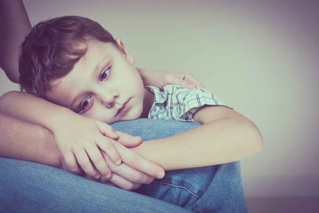 49451379 - A photo of a sad son hugging his mother at home. concept of couple family is in sorrow.