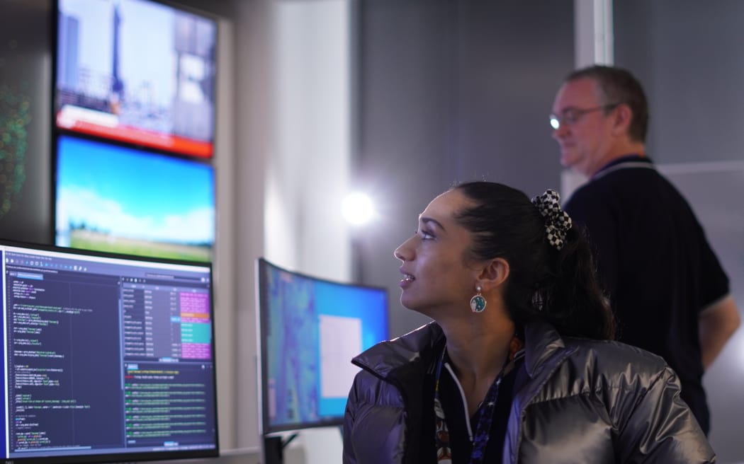 Ops engineers Mahima Seth and Vernon Lewis at the University of Auckland's mission control centre