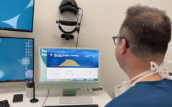 Dr Alex Buller checking the daily stats for their solar panel system.