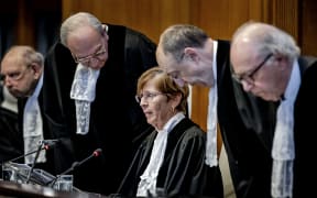 ICJ President Joan Donoghue (C) and ICJ judges arrive at the International Court of Justice (ICJ) prior to the verdict announcement in the genocide case against Israel, brought by South Africa, in The Hague on January 26, 2024. The top UN court said Israel should do everything it could to prevent any acts of genocide in the Gaza Strip, in a highly anticipated ruling. Israel must do everything to "prevent the commission of all acts within the scope" of the Genocide Convention, said the International Court of Justice on January 26, 2024. (Photo by Remko de Waal / ANP / AFP)