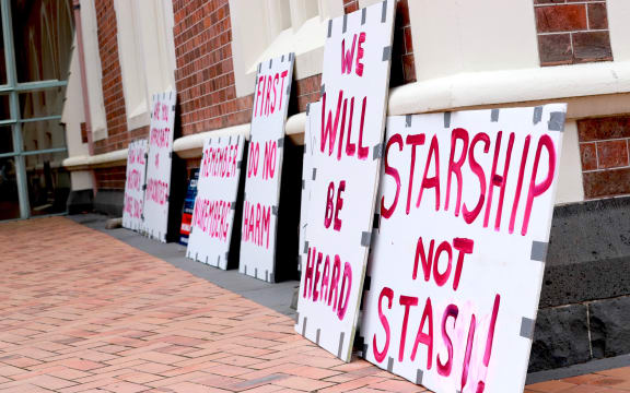 Signs outside the Court in Auckland on 30 November 2022 during a hearing on parents who wanted their baby to have blood transfusions only from someone who had not been vaccinated against Covid-19.