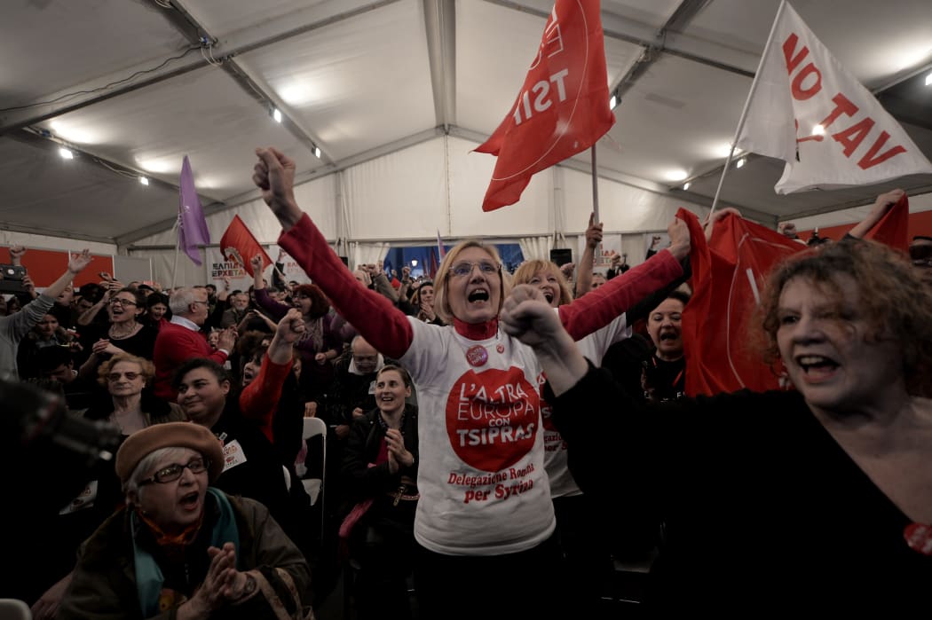 Anti-austerity Syriza supporters celebrate at the Syriza election kiosk in Athens in January 2015.