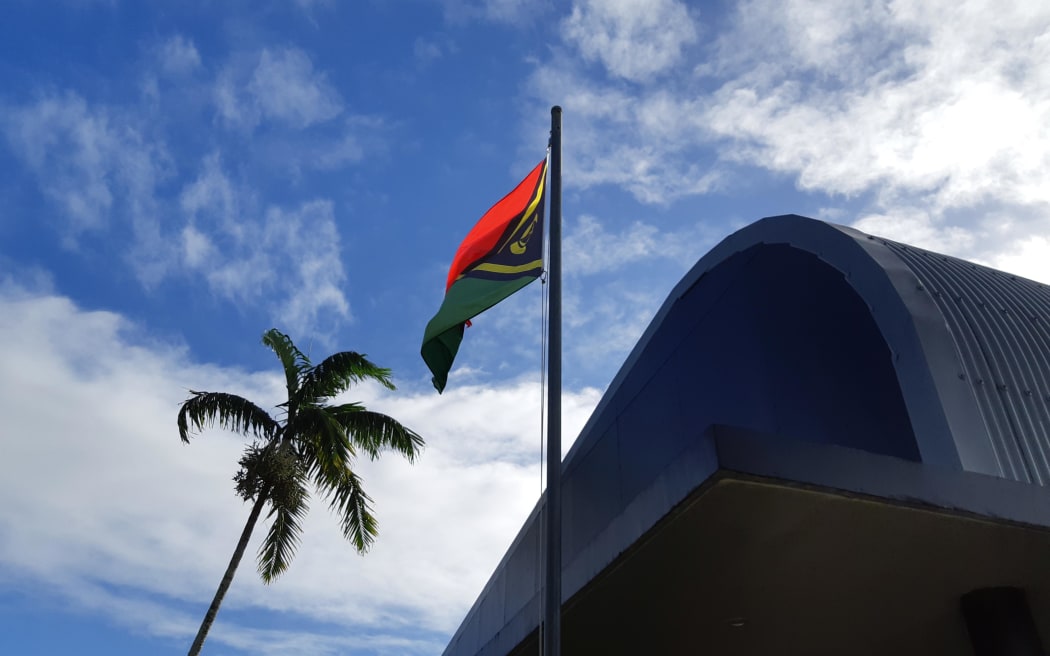 The Vanuatu flag flying above the buildings of the public broadcaster VBTC