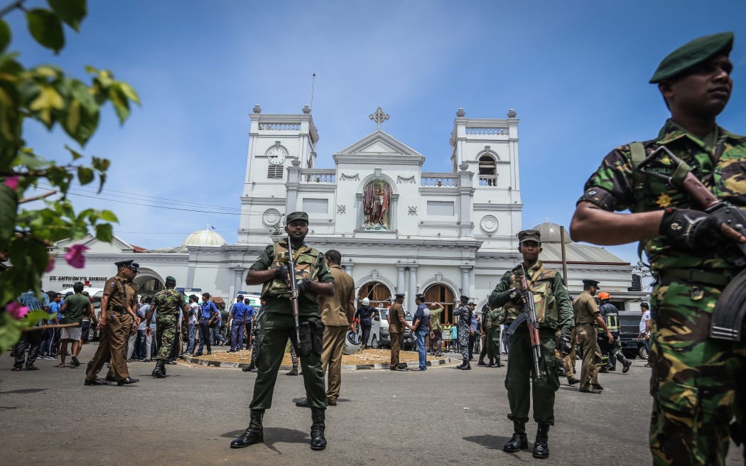 Sri Lankan military officers stand guard in front of the St Anthony's Church where an explosion took place in Kochchikade, Colombo, Sri Lanka.