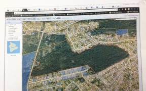 This map shows the 114.5 hectares of undeveloped land purchased by Bikini Islanders outside of Hilo on the island of Hawaii in green (bordered by an orange line), with existing housing around it.