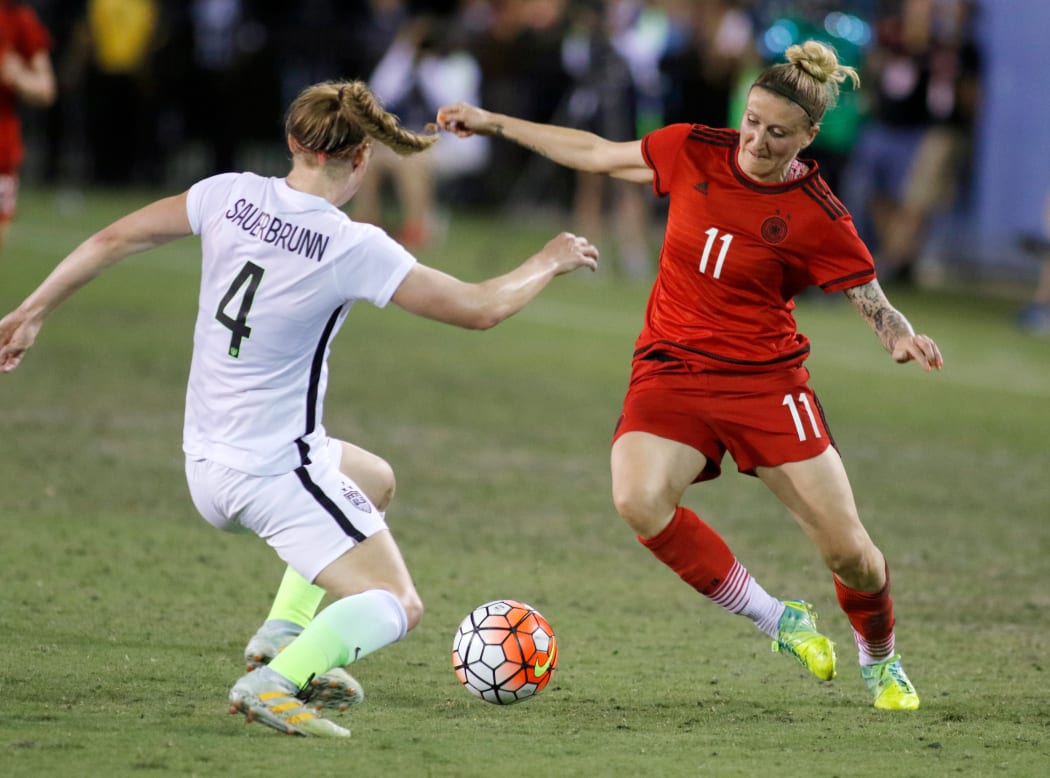 Becky Sauerbrunn of USA takes on Anja Mittag of Germany.