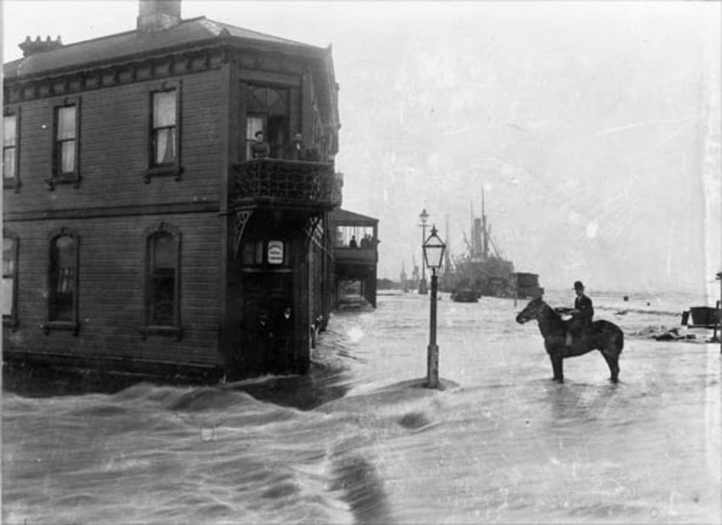 1906, Greymouth. The Imperial Hotel; in the distance ships are tied up at the wharf, on the lower reaches of the Grey River.