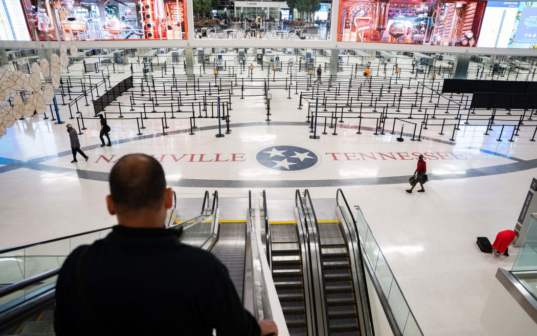 Travelers make their way to the gates during a temporary ground stop at the Nashville International Airport on 7 October in Nashville, Tennessee.