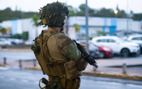 French soldiers of the 8th Marine Infantry Regiment (8e RIMa) secure the Magenta airport in Noumea, France's Pacific territory of New Caledonia, on May 17, 2024. France deployed troops to New Caledonia's ports and international airport, banned TikTok and imposed a state of emergency on May 16 after three nights of clashes that have left four dead and hundreds wounded. Pro-independence, largely indigenous protests against a French plan to impose new voting rules on its Pacific archipelago have spiralled into the deadliest violence since the 1980s, with a police officer among several killed by gunfire. (Photo by Delphine Mayeur / AFP)