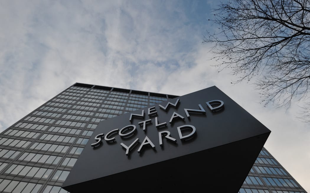 The New Scotland Yard sign stands outside the headquarters of the Metropolitan Police, in central London on January 11, 2013.