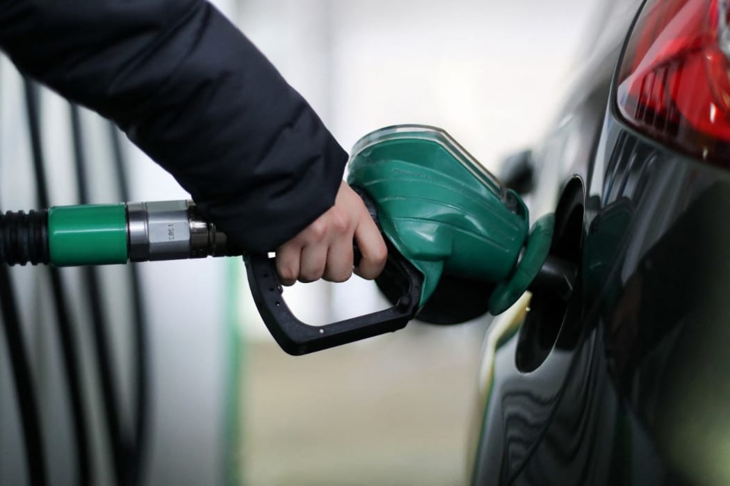 A motorist uses a pump as they re-fuel their car with unleaded petrol at a filling station in central London