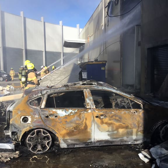 Crews putt out a blaze from a light aircraft which exploded as it smashed into a shopping centre near Melbourne.