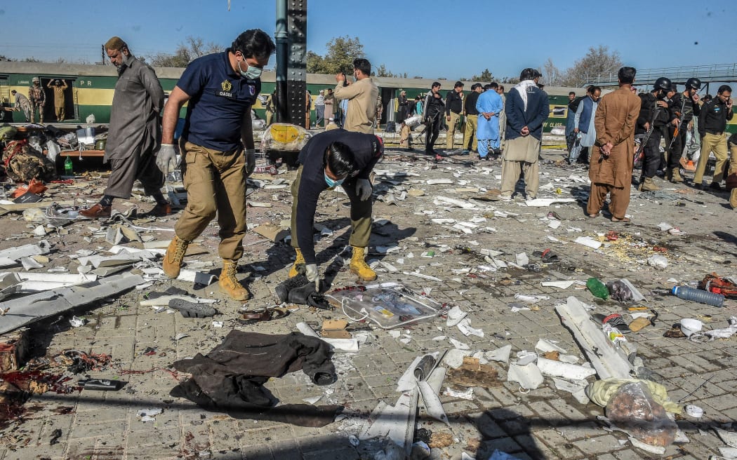 Security personnel inspect the blast site after an explosion at a railway station in Quetta, in Pakistan's Balochistan province on November 9, 2024. - Pakistani separatists killed at least 22 people on November 9 in a bombing targeting a railway station in Balochistan province, local officials and a militant group said. (Photo by Banaras KHAN / AFP)
