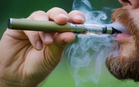 Close-up of a man vaping an electronic cigarette