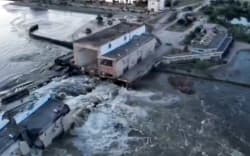 This screen grab from a video posted on Ukraine’s President Volodymyr Zelensky’s Twitter account on June 6, 2023 shows an aerial view of the dam of the Kakhovka Hydroelectric Power Station after it was partially destroyed.