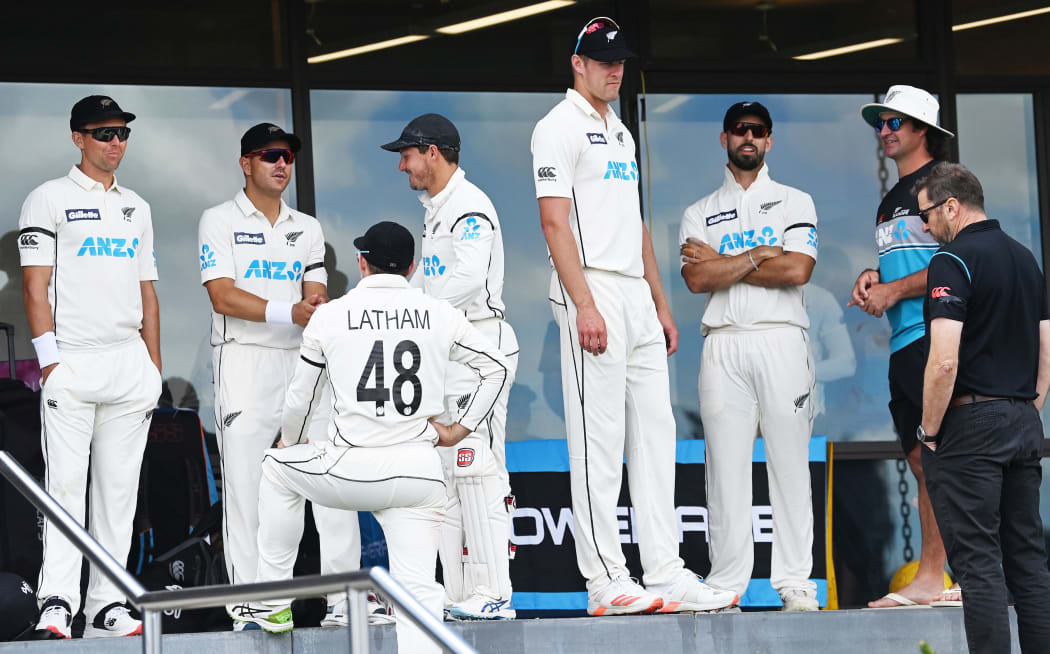 The Black Caps wait during a break in play at the Bay Oval.