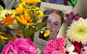 Flowers, photographs and notes at the end of Airport Drive in Bundaberg, in memory of missing teenager Pheobe Bishop. SINGLE USE