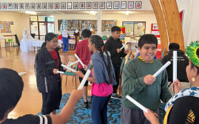 Young i-Kiribati children performing traditional Kiribati dance called the Te Tirere.