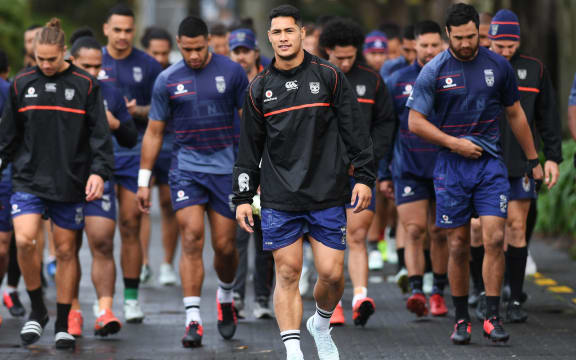 Warriors captain Roger Tuivasa-Sheck leads his team onto the training paddock.