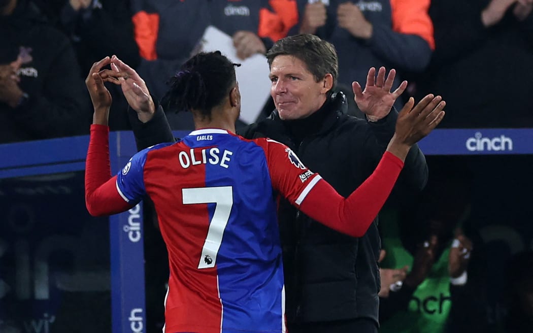 Crystal Palace's French midfielder Michael Olise (left) celebrates with Crystal Palace's Austrian manager Oliver Glasner (right) after scoring their fourth goal during the English Premier League football match between Crystal Palace and Manchester United at Selhurst Park in south London on May 6, 2024.