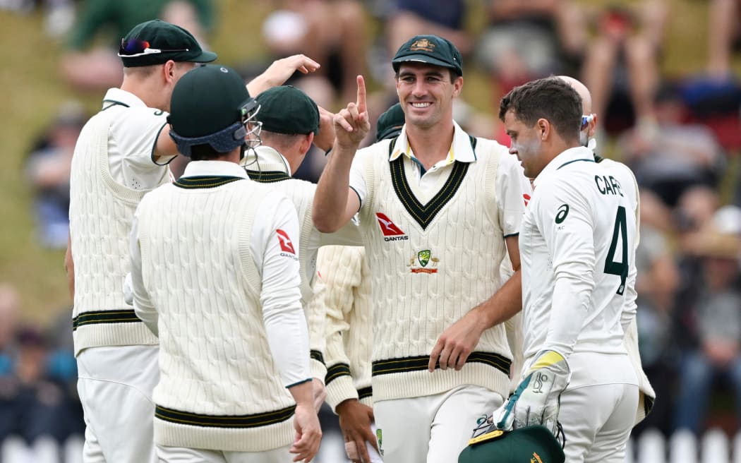 Australia's captain Pat Cumins and team mates celebrate on their way to victory over New Zealand, 2024.
