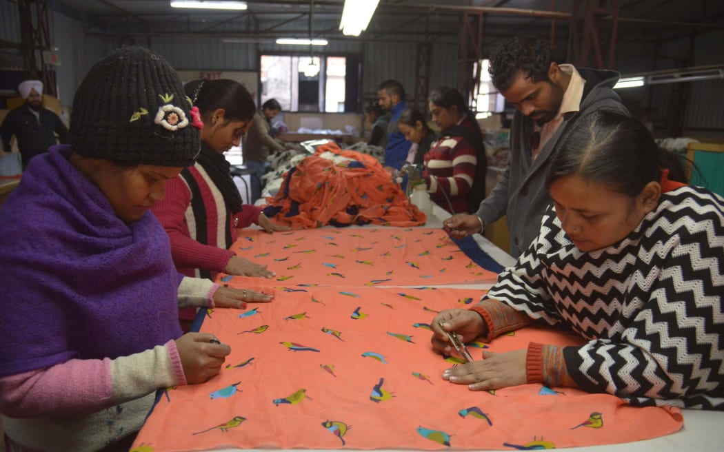 Workers in Amritsar checking wool shawls, which are exported globally from the factory.
