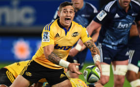 Hurricanes halfback TJ Perenara clears a ruck against the Blues