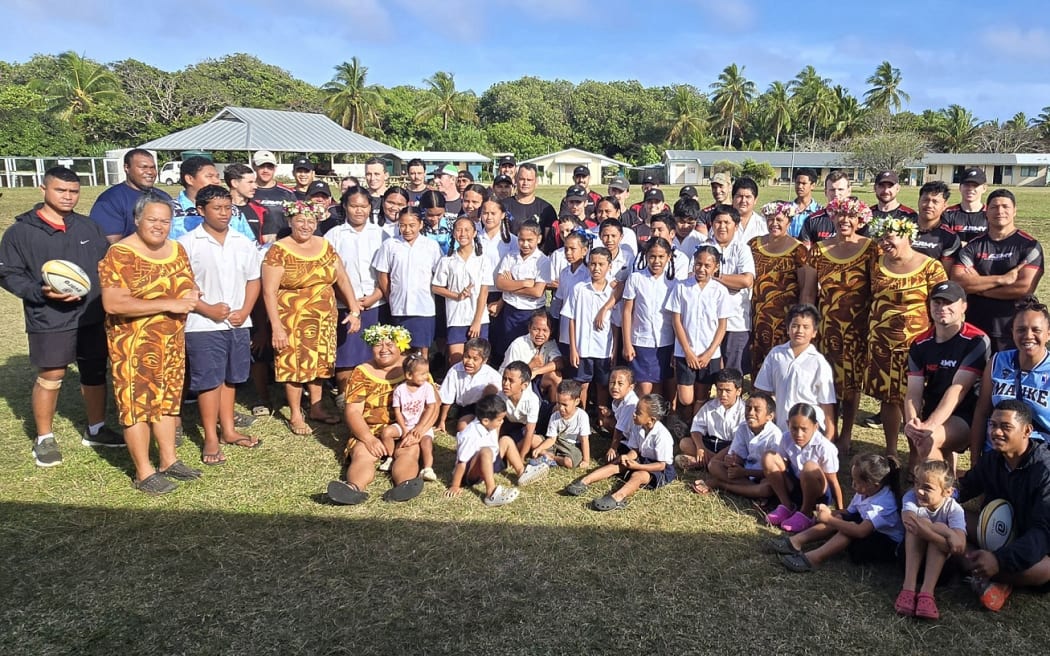 The Exercise Tropic Twilight contingent pose with the students and staff from Apii Ma’uke, the island’s school, after work was completed