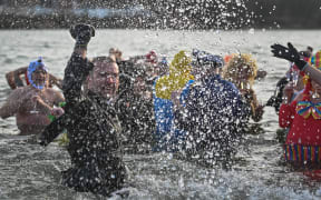 Swimmers from the Winter Swimming Club 'Sopelek' enjoyed a little less intense experience during the first winter swim of the season on New Year's Day swim, at Lake Zwirownia in Rzeszów, as winter temperatures remained higher than normal.
On Sunday, January 01, 2023, in Rzeszow, Subcarpatian Voivodeship, Poland. (Photo by Artur Widak/NurPhoto) (Photo by Artur Widak / NurPhoto / NurPhoto via AFP)