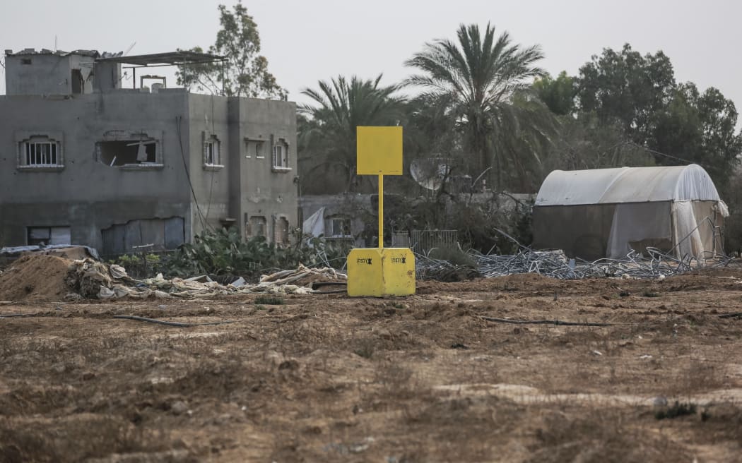 A general view of a concrete block marking the "Yellow Line" drawn by the Israeli military in Bureij, central Gaza Strip, on November 4, 2025. Israel has withdrawn its forces from Gaza's main cities, but still controls around half of the territory from positions on the Yellow Line, and has resisted calls to allow aid through the Rafah border crossing with Egypt. (Photo by Bashar Taleb / AFP)