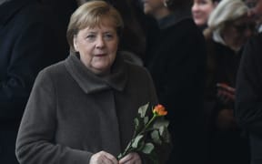 Angela Merkel, Chancellor of Germany, arrives with a rose in her hand at a commemoration ceremony for the 30th anniversary of the fall of the Berlin Wall, at the Berlin Wall Memorial at Bernauer Strasse in Berlin.