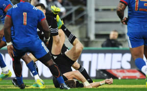 Beauden Barrett goes down.